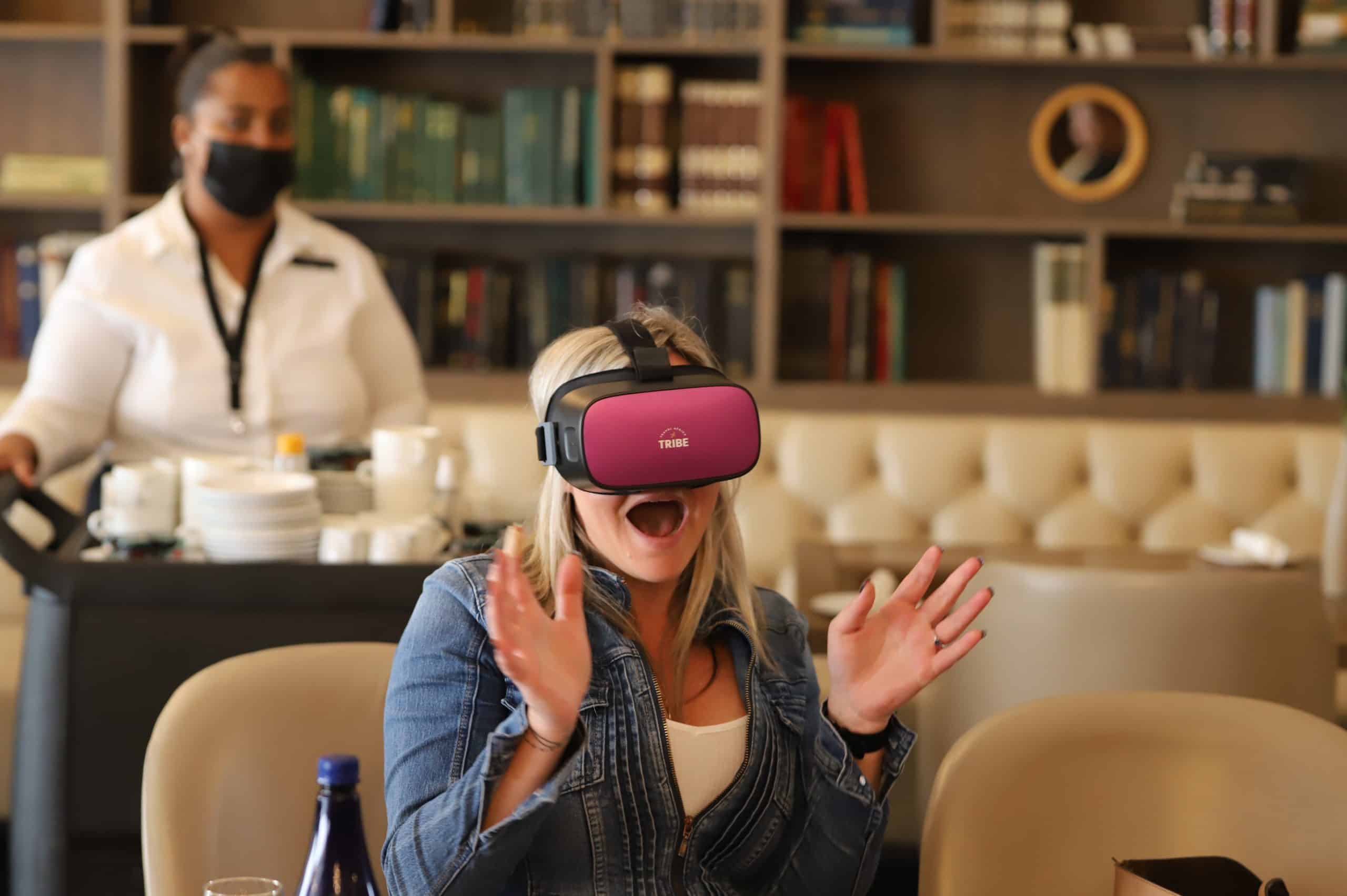 Female-getting-excited-using-a-DPVR-virtual-reality-wireless-headset-viewing-Travel-Africa-Network-VR-content